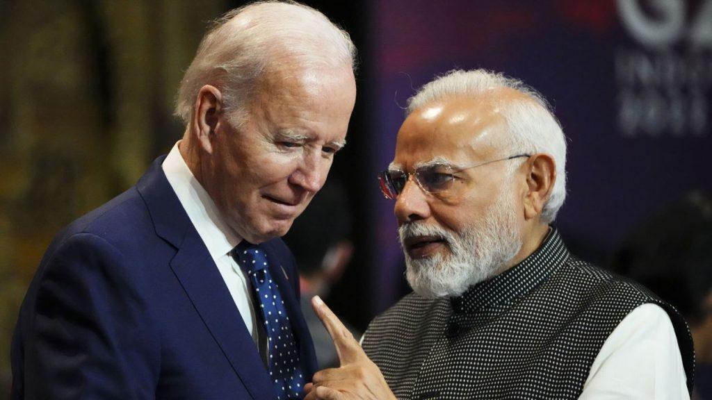 India's Prime Minister Narendra Modi talks with US President Joe Biden as they arrive for the first working session of the G20 leaders' summit in Bali on Tuesday